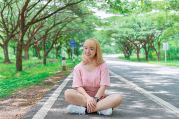 Obraz premium Portrait of beautiful asian girl golden hair with camera,Thailand people in pink dress,hipster girl