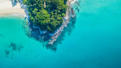 Aerial view tropical island with white sand beach and blue clear water and granite stones at Andaman sea, View from above beautiful beach of Andaman sea, Phuket, Thailand, Asia - obrazy, fototapety, plakaty