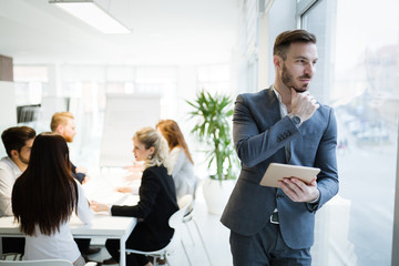 Businessman in modern office using tablet