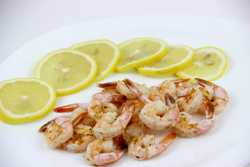 seafood. shrimp on a plate with lemon.