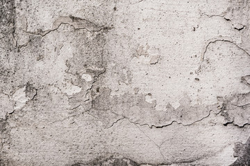 Old white cracked plaster wall surface for background or texture