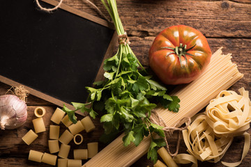 Italian food cooking ingredients. Pasta, vegetables. Top view with copy space