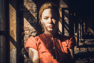  background of old brick wall and window girl in red dress