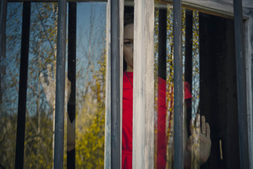 peeking in the crack in the window the girl in the red dress