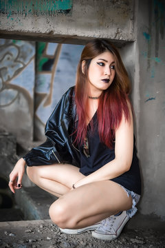 Portrait of asian with black leather dress punk style,Thailand people take a picture