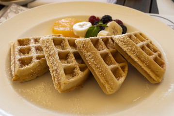 Dish waffles and red fruits full breakfast.