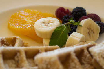 Dish waffles and red fruits full breakfast.