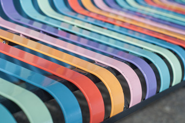 closeup of colorful metallic bench in the street