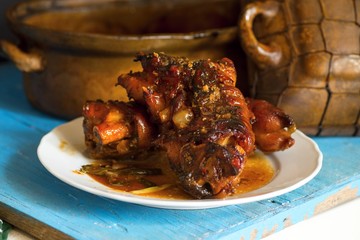 Baked pork legs in spicy vegetable sauce.
