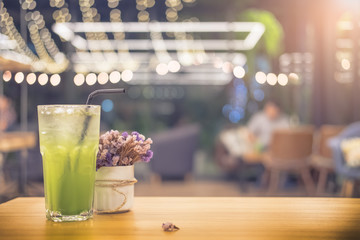 Fruit coctail and flower in cafe with sun flare, copy space and vintage tone