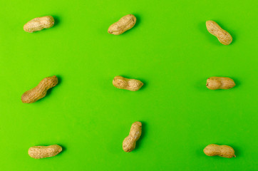 Peanuts on a bright green background.