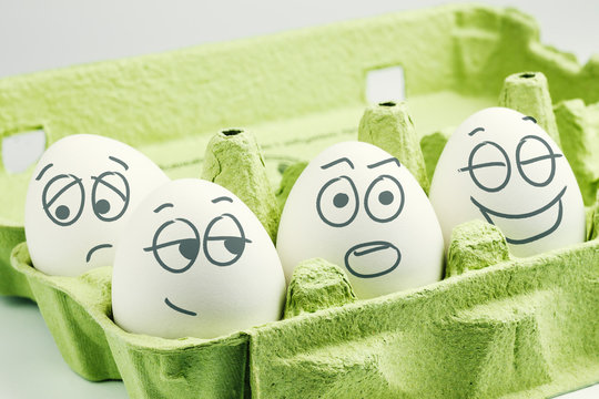 Four eggs in eggbox. Types of temperaments. Sanguine, choleric, phlegmatic and melancholic.