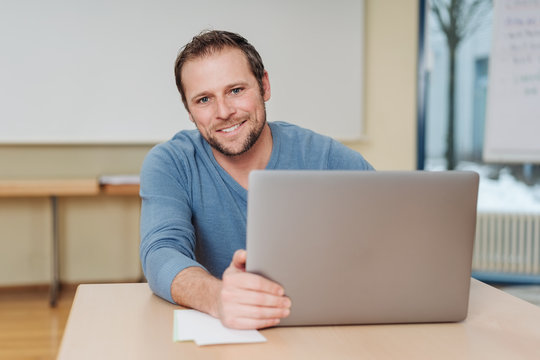 Cheerful man sitting in front of computer