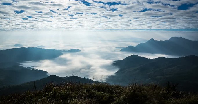 Time lapse of beautiful sun rays shining upon the mountainous landscape at Phu Chi Fah national Park.