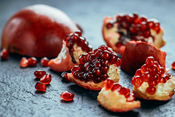 Fresh ripe pomegranate on a slate plate kitchen table