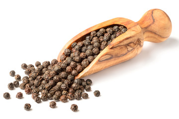 dried black peppercorns in the olive wood scoop, isolated on white