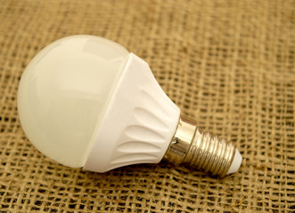 White light bulb on burlap