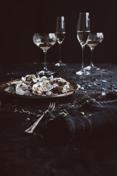 Plate of prepared fresh oysters on ice and white wine