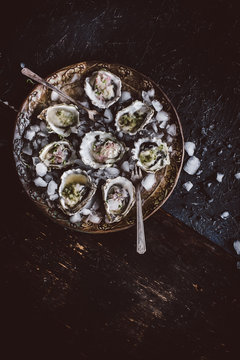 Fresh oysters with serrano cilantro mignonette sauce on plate