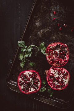 Halved pomegranates on tray