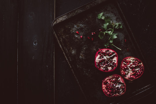 Halved pomegranates on tray
