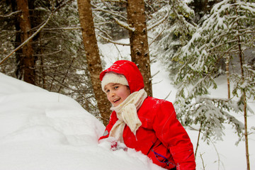 Happy little girl playing in the snow