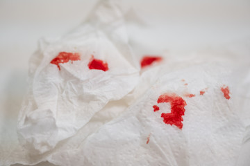 Fototapeta na wymiar Red blood on tissue toilet paper.