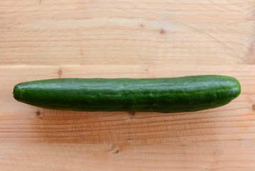 cucumber and tomatoes on wooden background