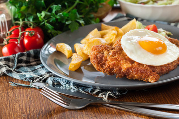 Breaded viennese schnitzel with fried agg