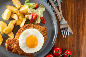 Breaded viennese schnitzel with fried agg