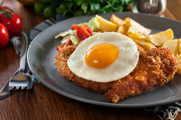 Breaded viennese schnitzel with fried agg