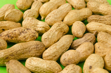Peanuts on a bright green background.