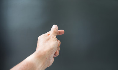 Obraz na płótnie Canvas Finger gestures and wrinkled hands On a gray background