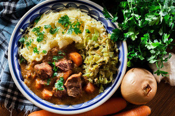 Traditional irish stew served with potatoes and cabbage