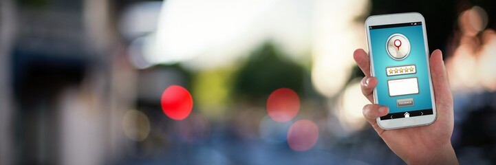 Composite image of hand holding mobile phone