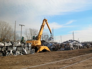 Junkyard crane with maginet moving scrap recycled steel