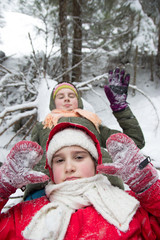 Two happy little girls in snowy forest