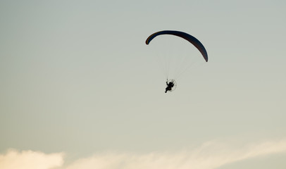 Paramotor, flying on a beautiful sky at sunset             