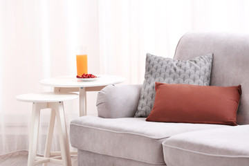 Fototapeta na wymiar Cozy grey sofa in modern room