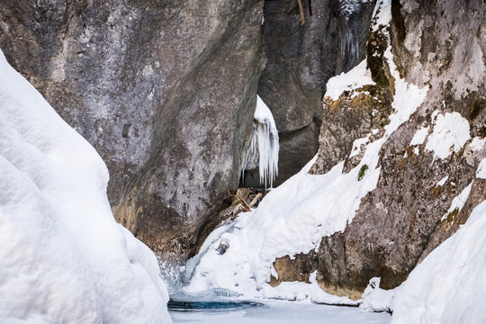 Frozen icy waterfall in snow covered gorge Baerenschuetzklamm in winter