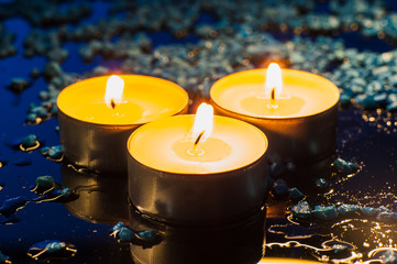 Single lit candles.Candles new year.