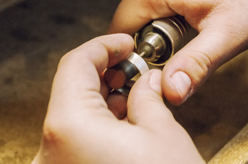 Craft jewelery making. Ring polishing. Macro shot.