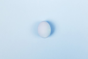 Blue egg on blue background. Top view