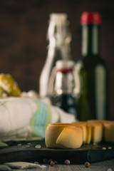 Several pieces of smoked rolled cheese on wooden board
