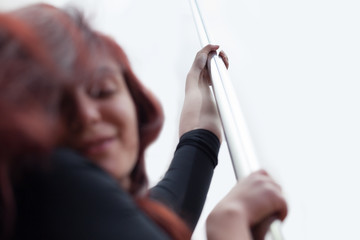 young woman pole dance practicing at studio