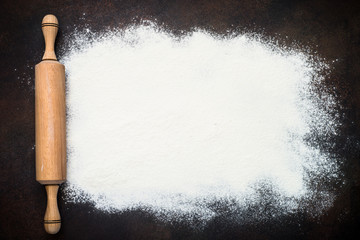 Flour and rolling pin top view. 