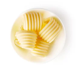 Schilderijen op glas Butter curls isolated on white, from above © bigacis