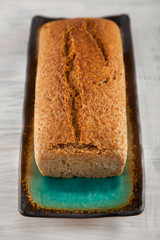 fresh wholegrain bread on white wooden kitchen table can be used as background