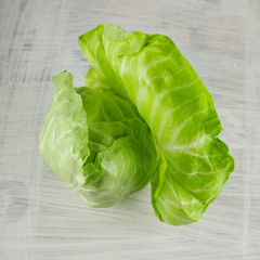 fresh green pointed cabbage on white wooden kitchen plate, can be used as background