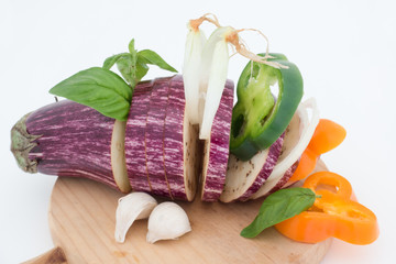 Colorful cut vegetables composition on wooden cutting board
